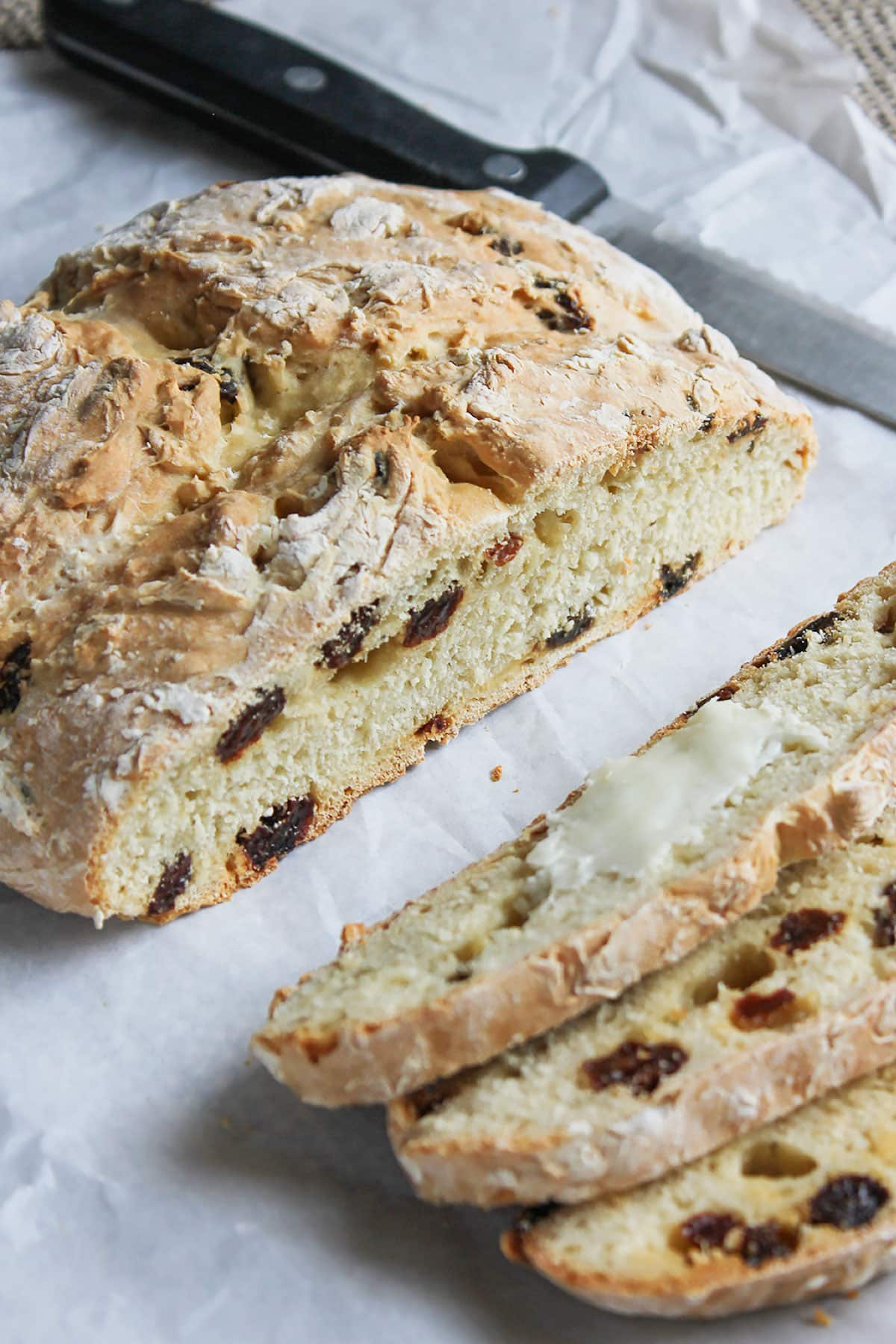 Freshly baked Irish soda bread on parchment paper.