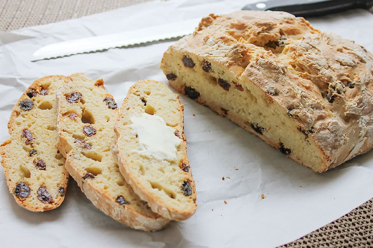 Irish soda bread cut into slices with butter.