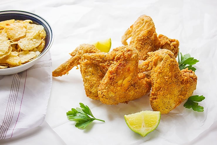 Golden and crispy chicken wings on parchment paper.