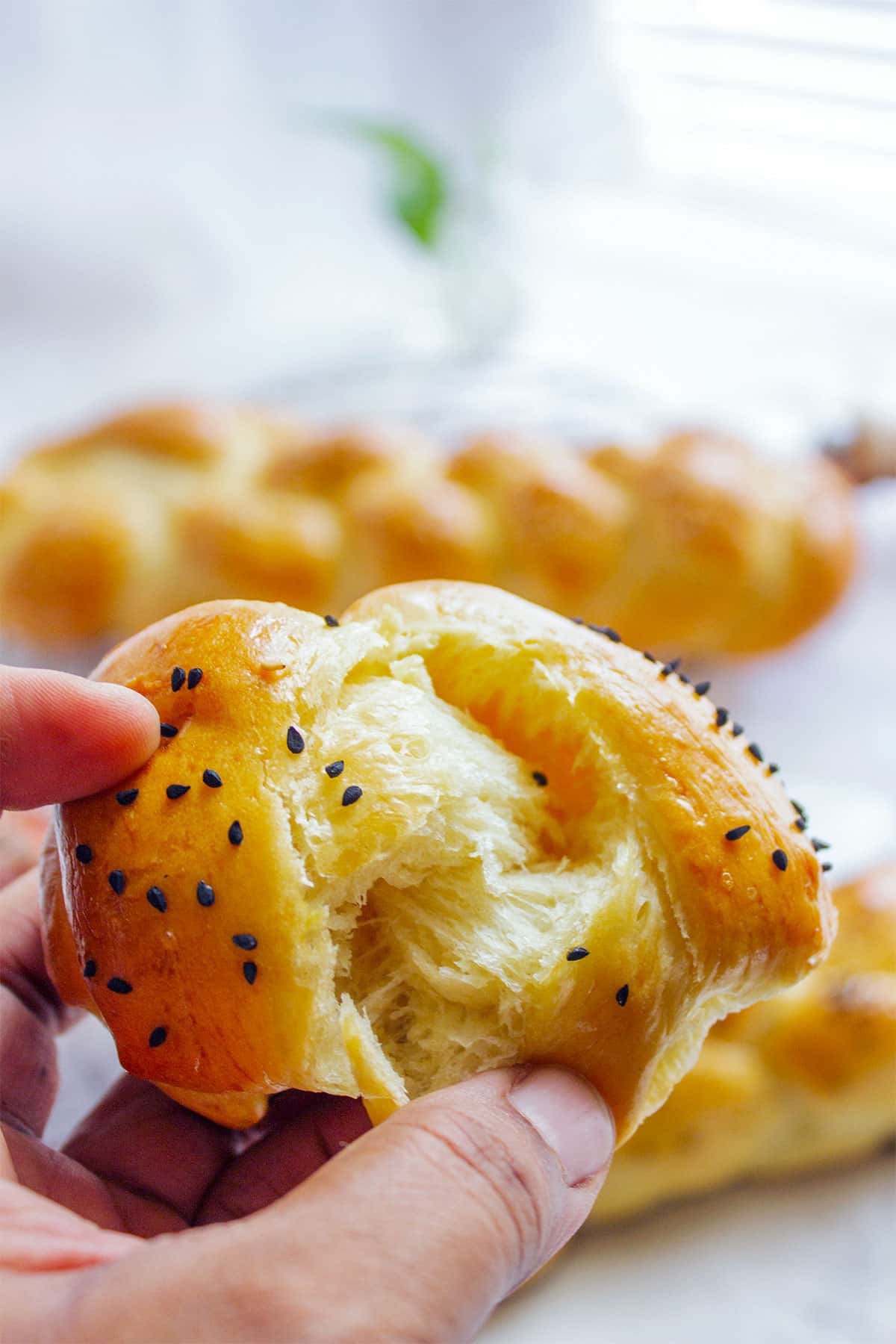 Showing tender crumbs inside the braided sweet milk bread.