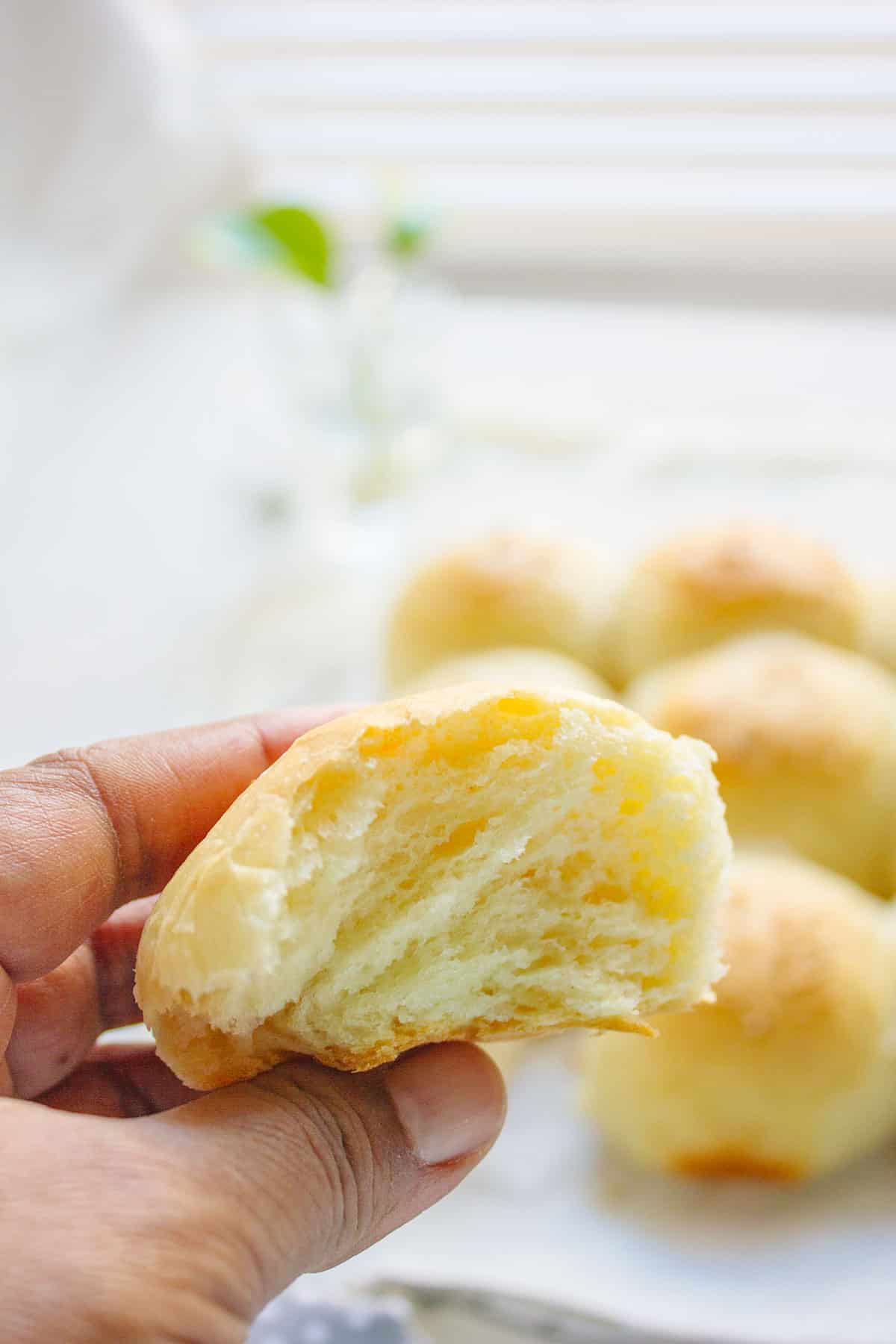 Showing how light and fluffy the dinner roll looks form the inside.