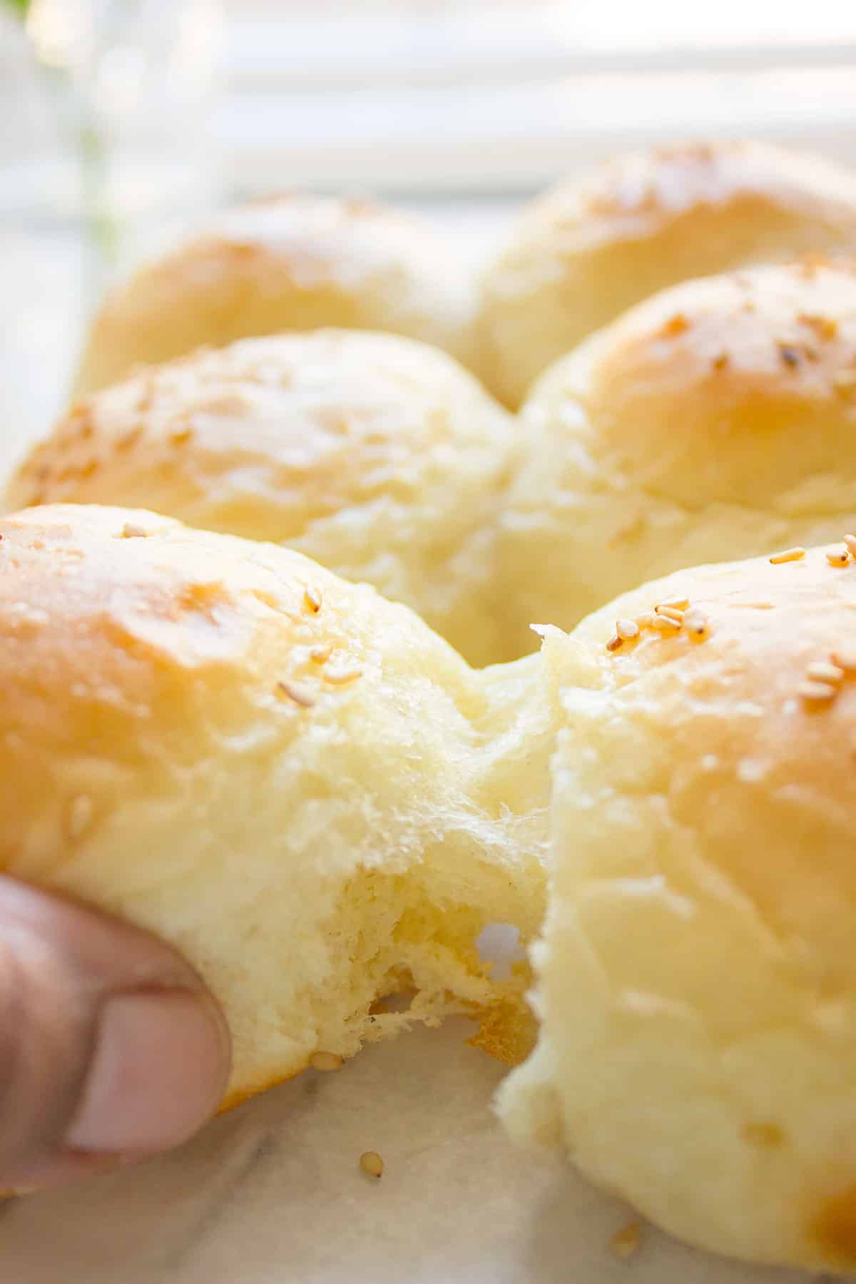 Pulling the fluffy dinner rolls from another.