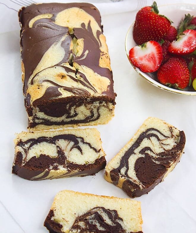Marble pound cakewith slices and strawberry on the side.