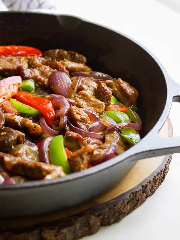 pepper steak in a black iron skillet.
