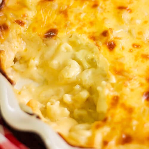 Side shot of baked macaroni and cheese showing the cheese sauce.