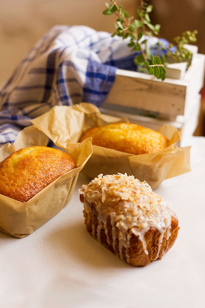 Coconut loaf cake with icing and toasted coconut.
