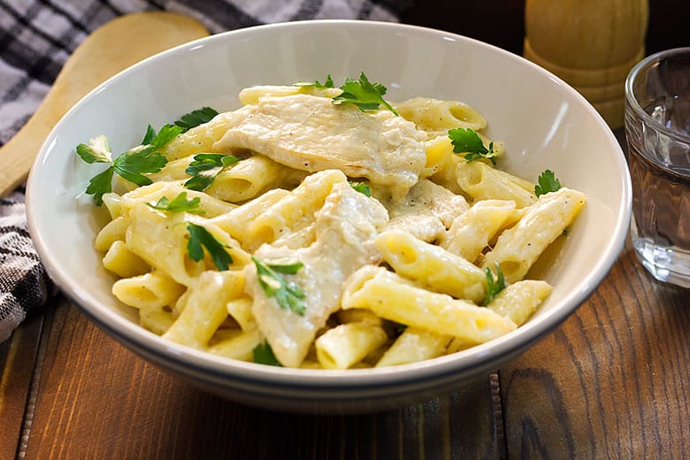 Chicken Alfredo served in a medium size bowl.