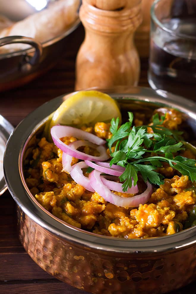 Freshly made chicken keema with lemon slice on the side.