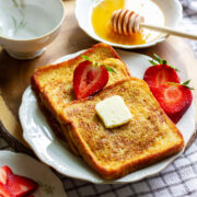 Flavorful French Toast served with butter and strawberries.
