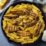 Creamy chicken pasta served in a black cast iron. Feature image 2024.