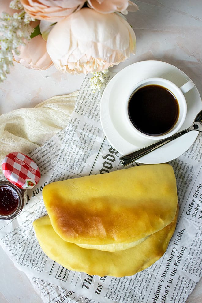 Coco bread served with coffee and jam.