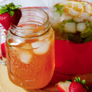 Close up image of strawberry lemonade with slices of lemon.