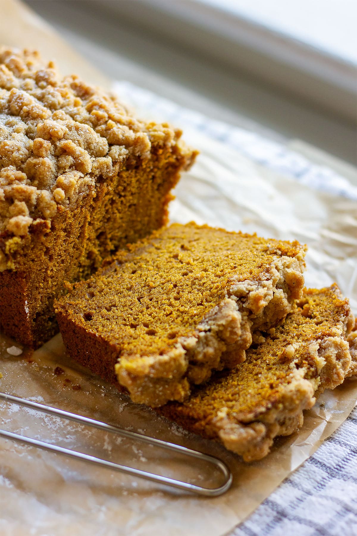 Pumpkin crumb cake slices over parchment paper.