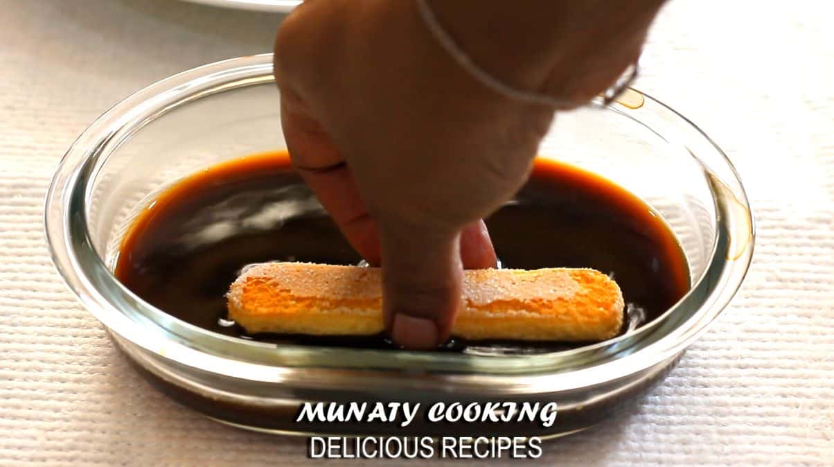 Dipping ladyfinger in espresso.