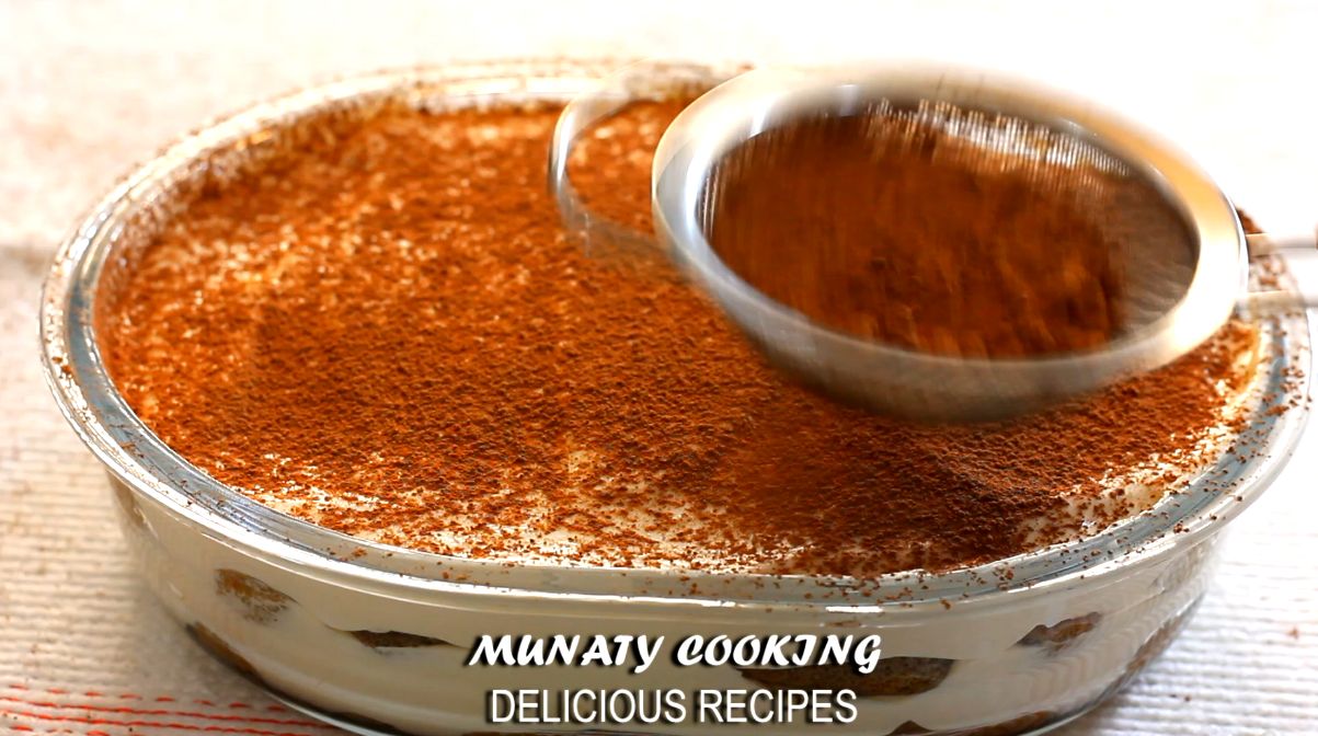 Dusting tiramisu with cocoa powder before serving.