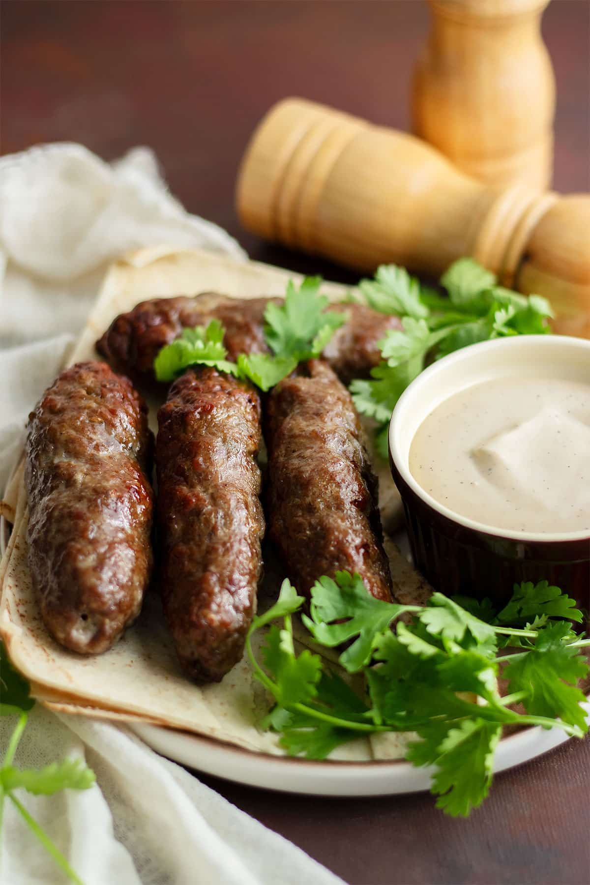 Juicy and tender kofta served on a plate with tahini sauce.