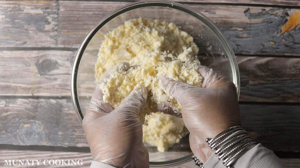 Rubbing butter with flour in a bowl.