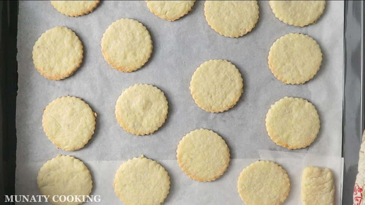 Freshly baked coconut cookies on baking sheet.