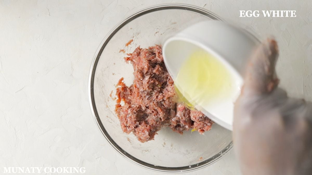 Mixing ground meat with spices and egg white.