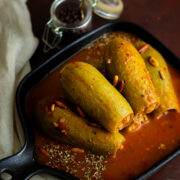 Kousa mahshi in a delicious tmoato sauce. Stuffed Summer squash with rice and meat.