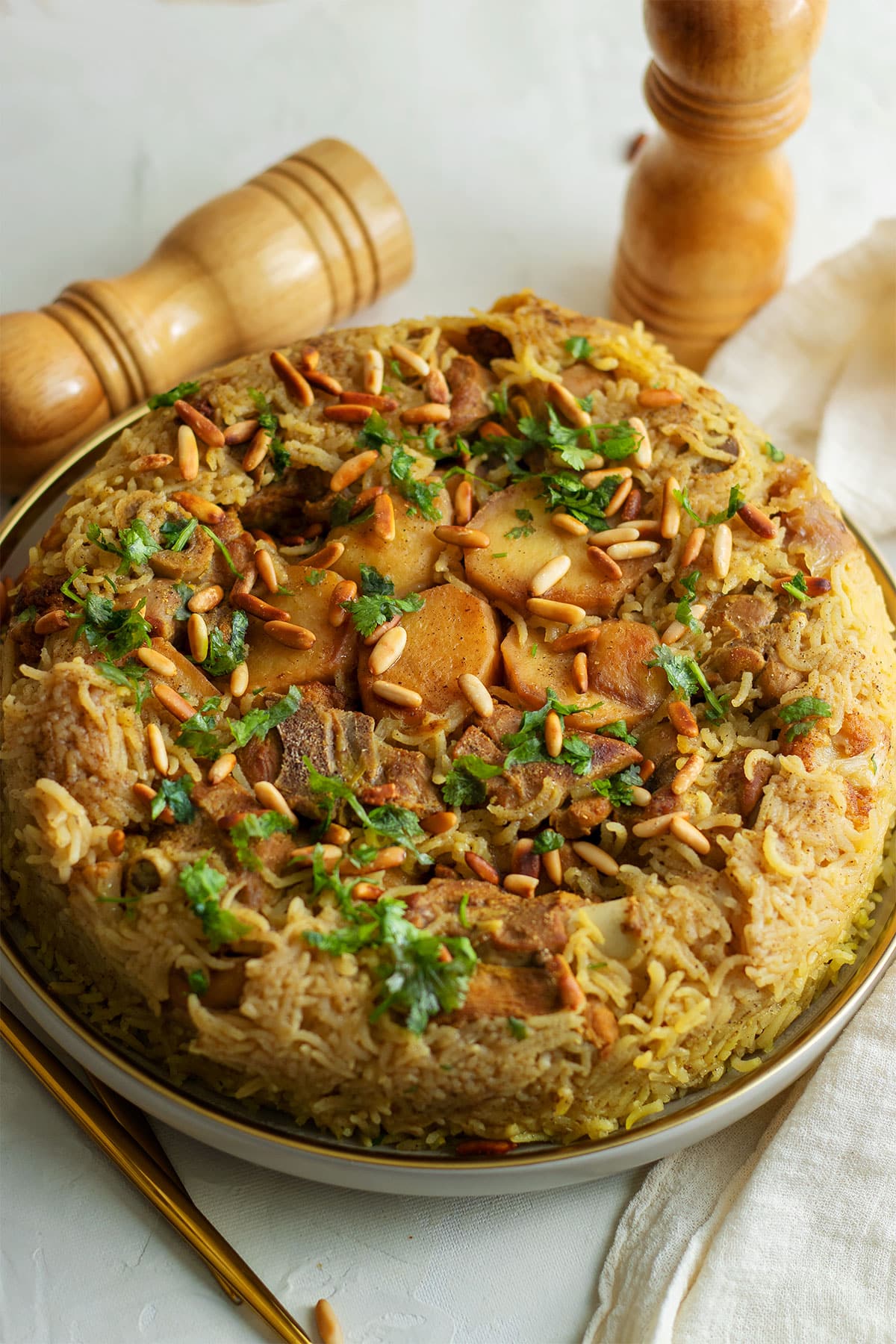 Maqluba with lamb garnished with Toasted pine nuts and chopped parsley.