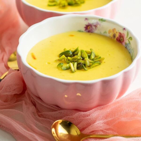 Creamy saffron custard enjoyed in Ramadan, served in a pink bowl.