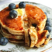 Blueberry souffle pancake stack served with fresh blueberries and butter.