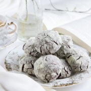 Fudgy chocolate crinkle cookies served on a white plate.
