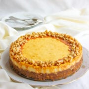 Vanilla cheesecake topped with butterscotch sauce and toasted walnuts.