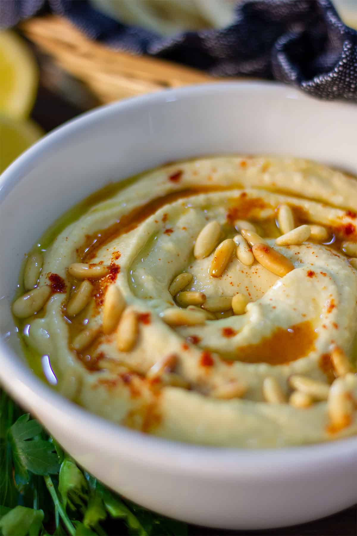 Close up image of freshly prepared creamy hummus in a bowl.