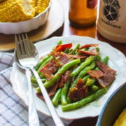 Green Beans with Turkey Bacon freshly served in a white plate.