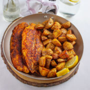 Pan fried fish served with roasted potato in a pan.