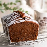 Chocolate pound cake loaf close image. Showing cake with icing and garnished with pecans.