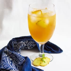 Ginger Iced tea Freshly made and served in a glass full of ice with ginger slices.