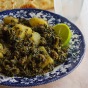 Ground beef and spinach close up image served with slice of lemon.