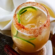 Homemade Apple Cider in a glass with ice cubes.