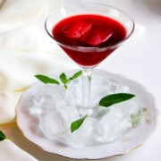 Sorrel tea served in a glass with ice cubes.