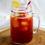 Strawberry iced tea served in a mug with ice cubes.