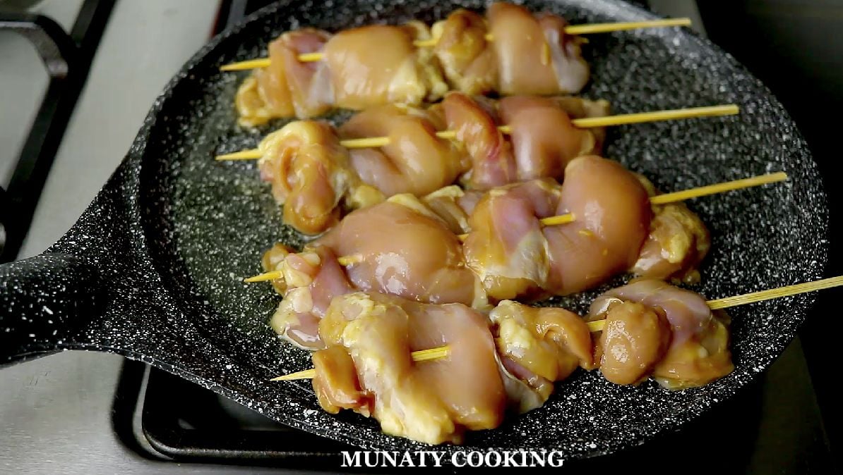 Cooking the chicken skewers.