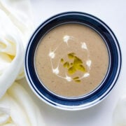 Close up shot of lentil and potato soup served in a bowl.