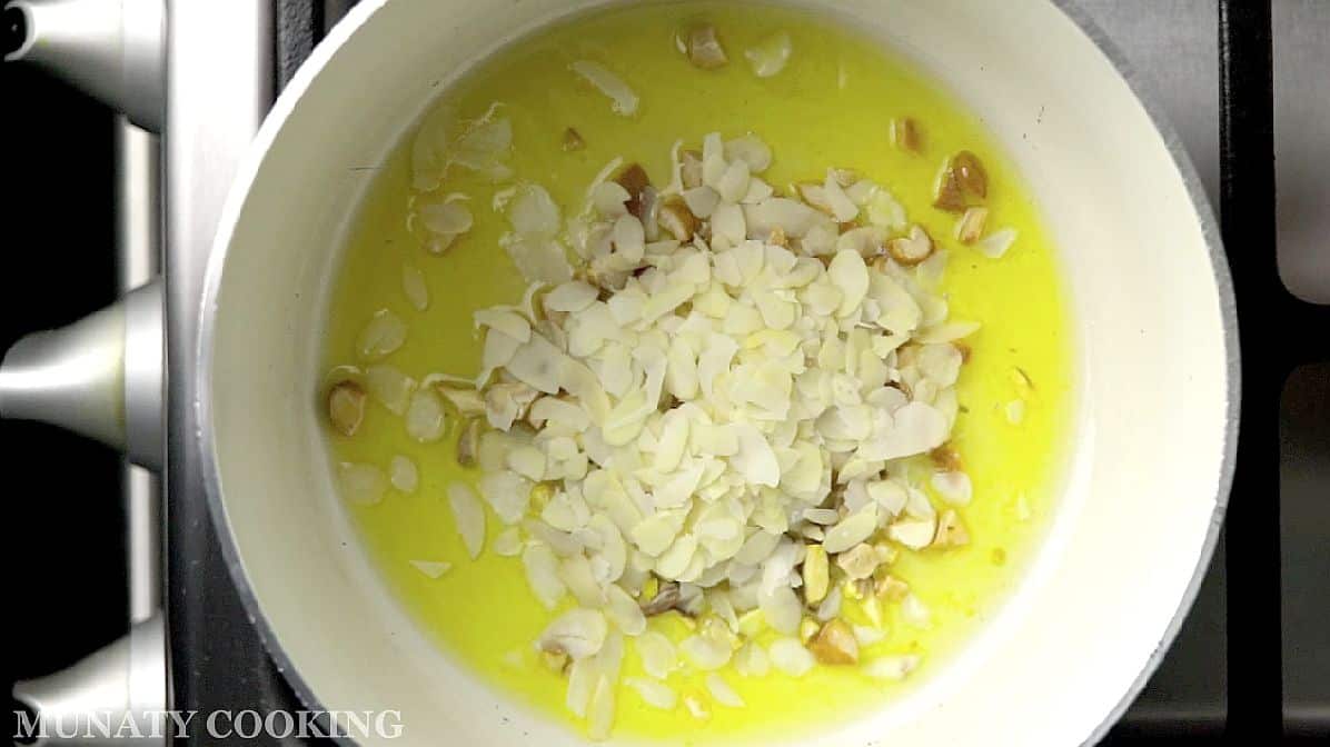 Roasting the nuts in ghee.