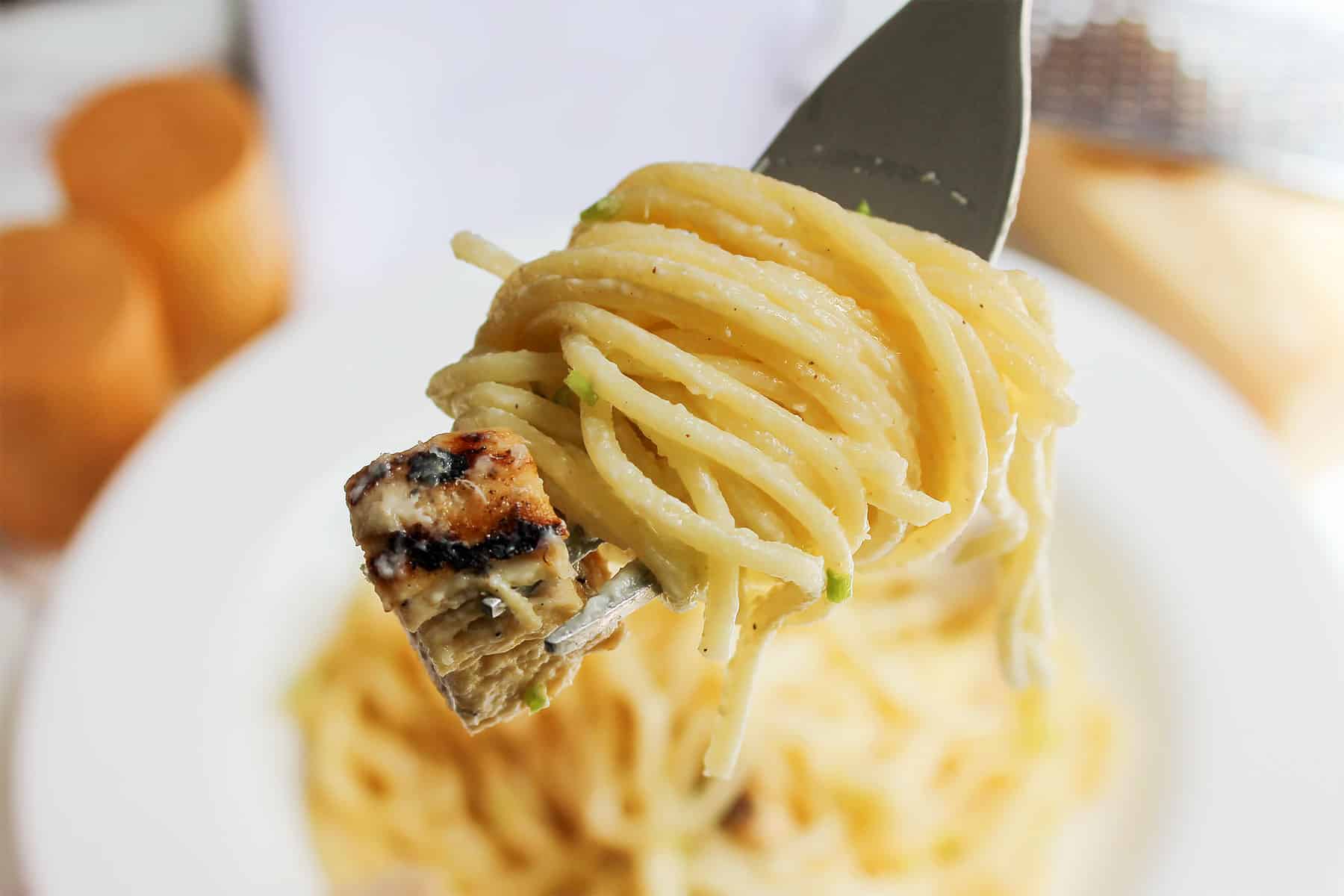 A portion of pasta with loa calorie creamy sauce and chicken.