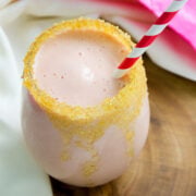 Strawberry banana coconut smoothie, a vegan drink served in a glass.