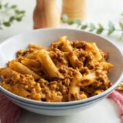 One pot cheeseburger pasta served in a white bowl.