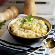 Freshly prepared Southern Creamed Corn servind in a black bowl.