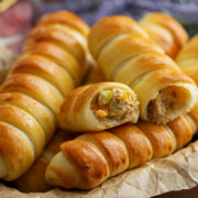 Close up image of tuna bread rolls served on parchment paper.