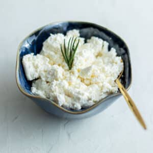 Homemade Ricotta Cheese served in a small bowl.