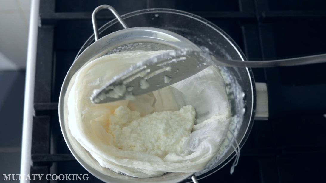 Draining the ricotta using cheesecloth.