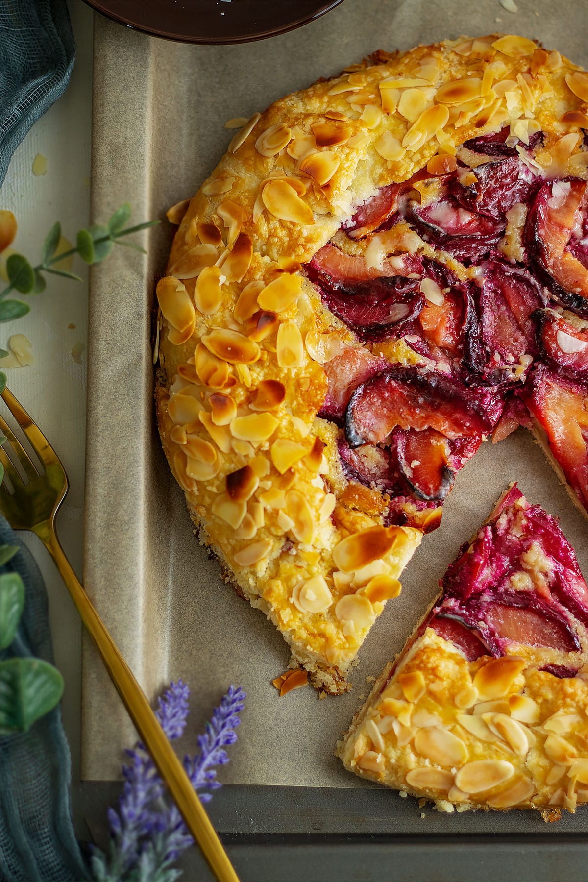 Close up image of plum galette on a parchment paper.