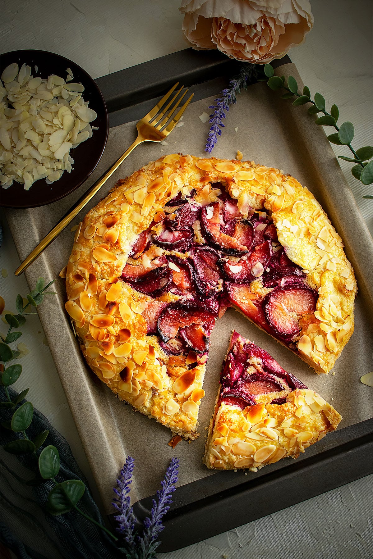 Freshly prepared plum galette with frangipane.